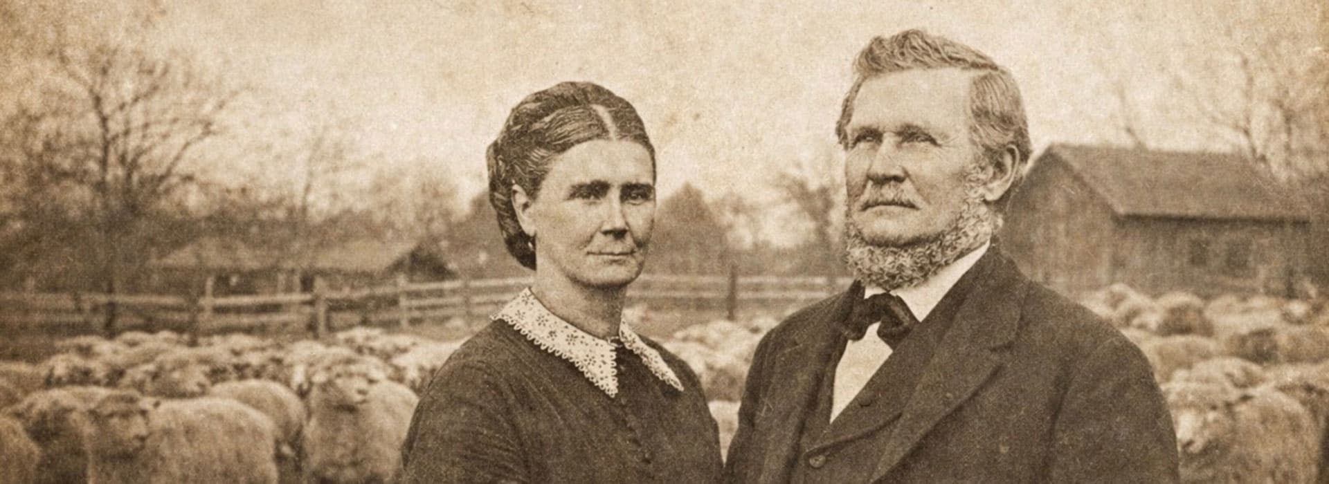A historical portrait of a woman and man standing confidently in front of a flock of sheep.