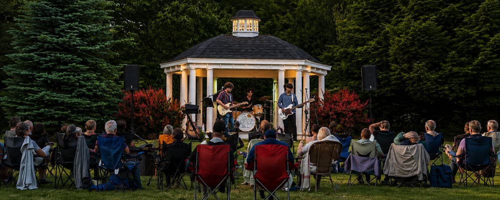 Bayleaf Band performs live from the gazebo as guests enjoy the Annual Backyard Concert at Stag's Leap Farm Bed & Breakfast in Oxford, Michigan.